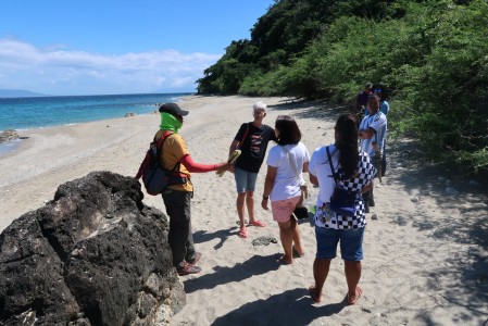 A group of people discussing the beach condition.